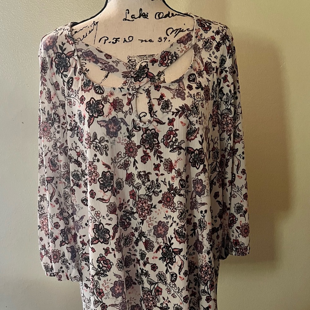 Beautiful flowered half sleeved blouse was purchased and never worn washed once